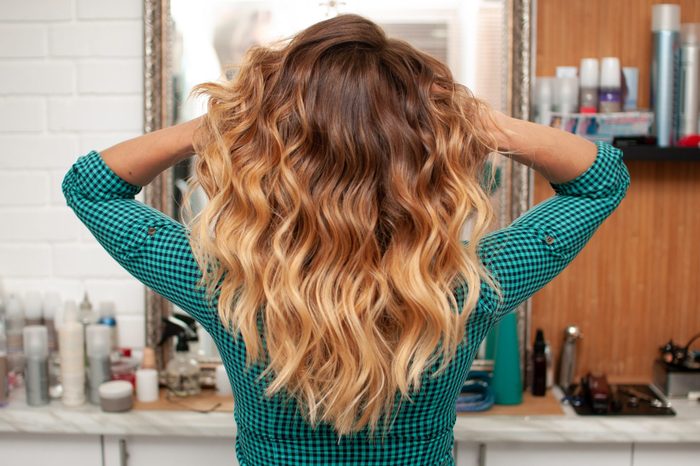Beautiful ombre hair coloring on a girl with long hair, view from the back