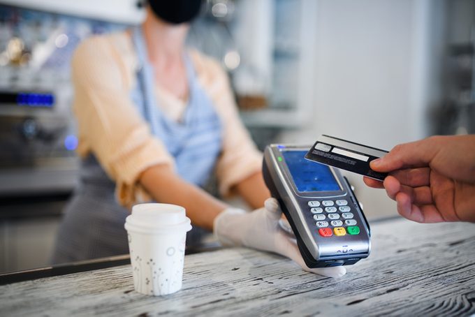 Contactless payment with debit card, coffee shop open after lockdown
