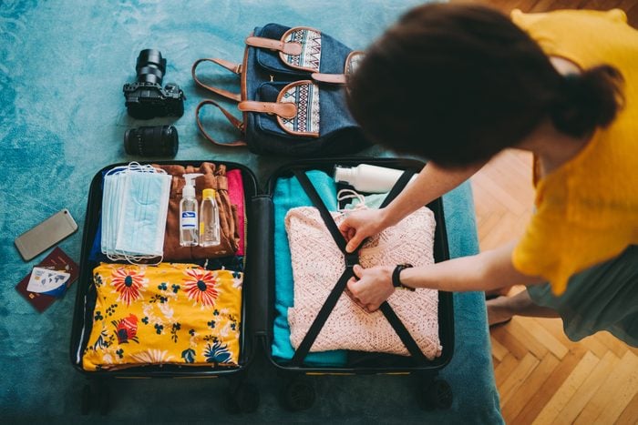 Woman packing suitcase for travel