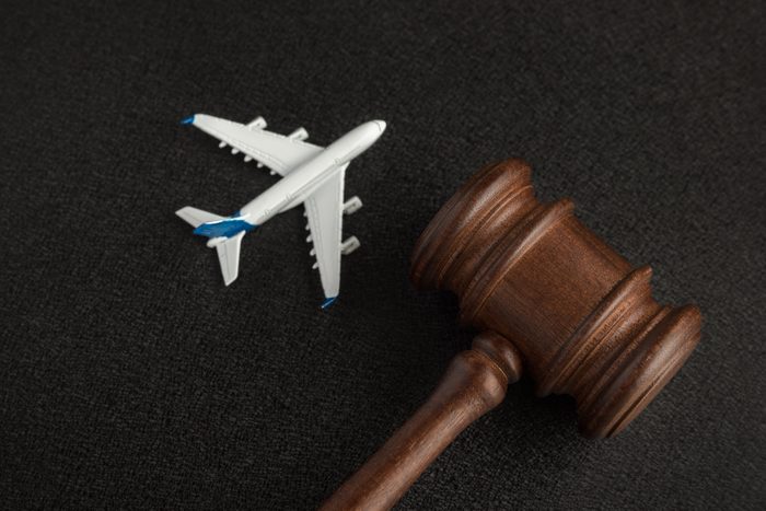 Wooden judges gavel and toy plane for an aviation law concept