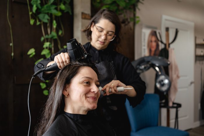 Woman dyeing and cutting her hair in the beauty salon