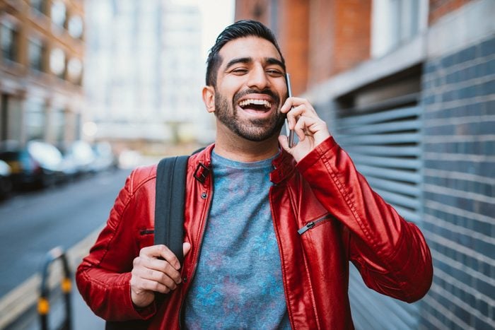 Man is using mobile phone to talk to friends