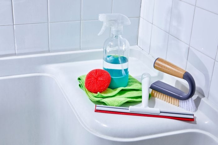 cleaning supplies arrange in a shower