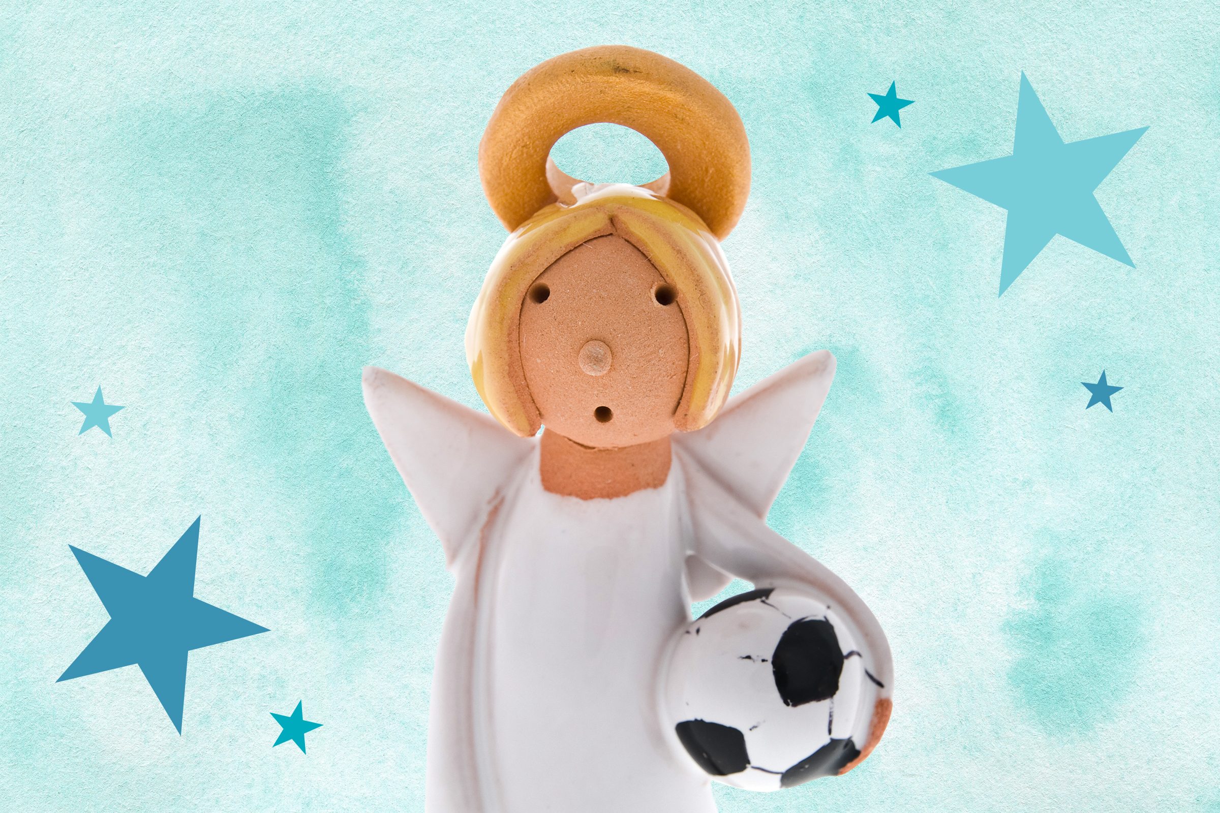 Figurine of an angel holding a soccer ball