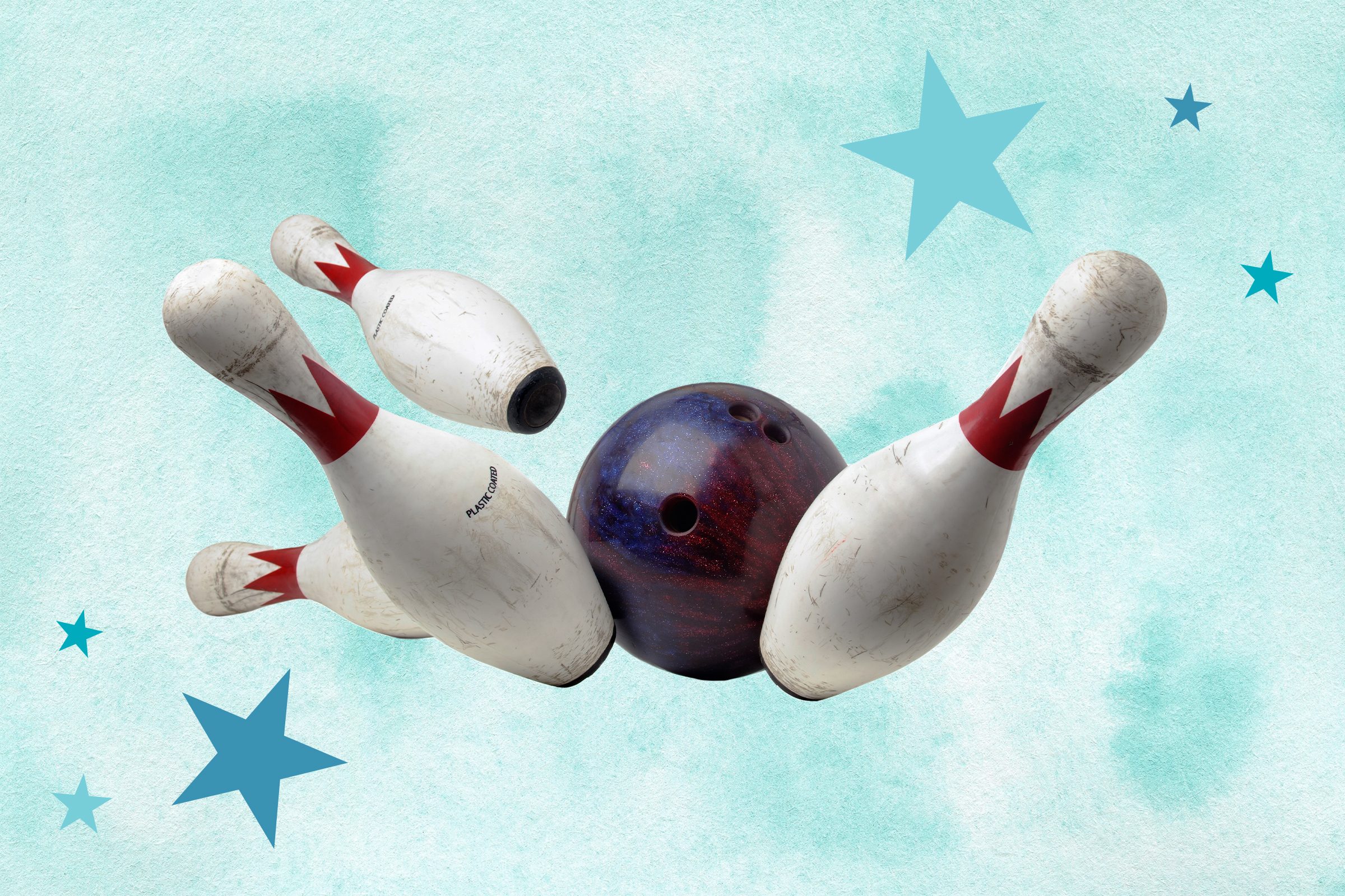 Bowling ball knocking into four bowling pins