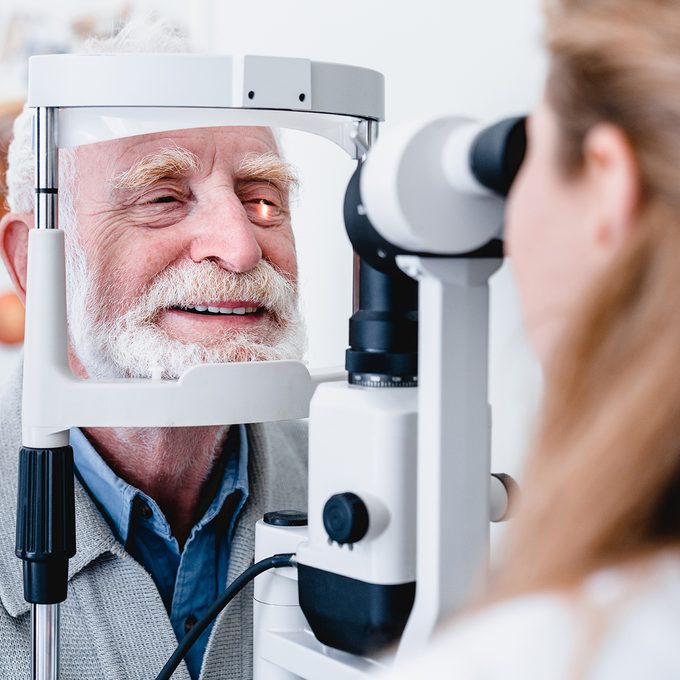 doctor checking a man's eyes
