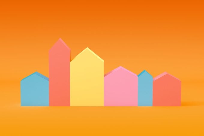 colorful house shaped blocks in a row on orange background