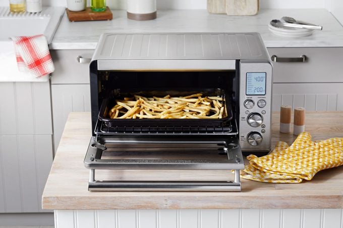 mcdonalds fries in an open toaster oven in a modern kitchen