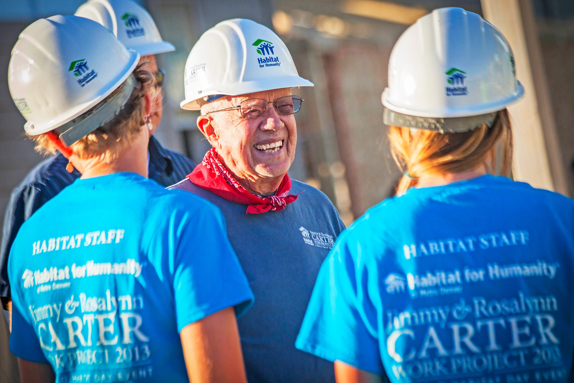 Jimmy Carter I na construction hat standing with other workers