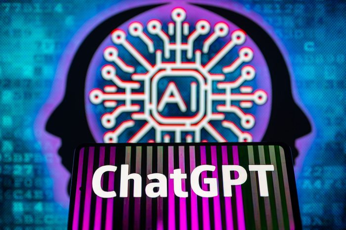 Open AI ChatGPT on a Mobile Screen with AI brain on Screen Behind It