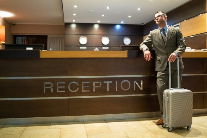 Bored businessman waiting on hotel's reception