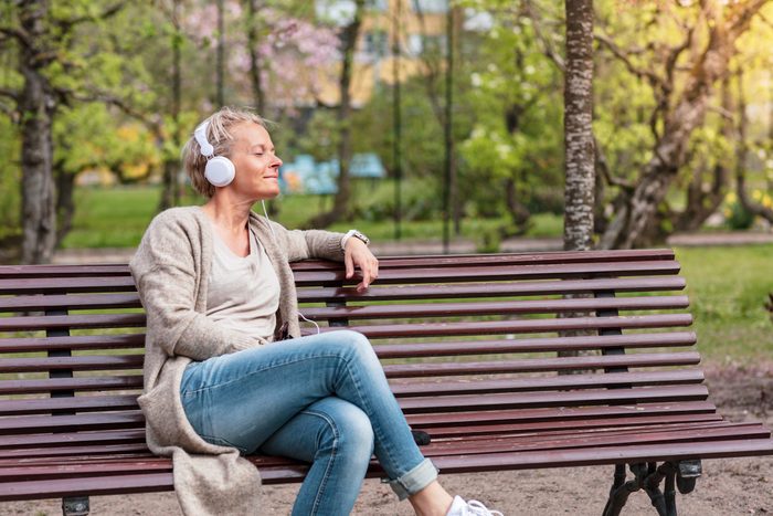 Woman listening to music in a park