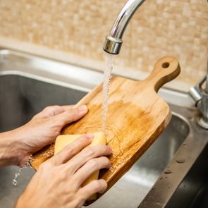 Cleaning wood cutting board in kitchen sink
