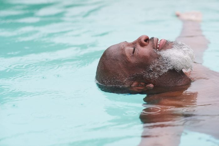 A mature man relaxes in a pool