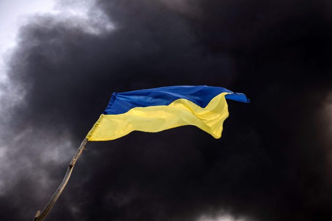 UKRAINE flag with a black smokey sky