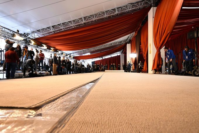 Media photograph the champagne-colored carpet for the 95th Oscars red carpet arrivals area as it is rolled out along Hollywood Boulevard