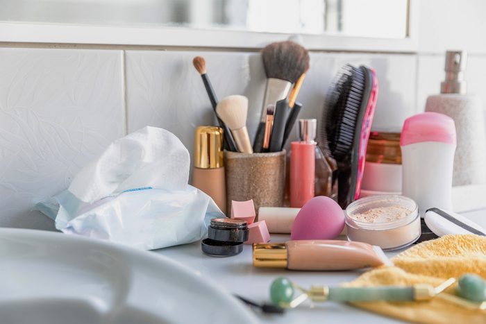 Messy cosmetics displayed on bathroom counter