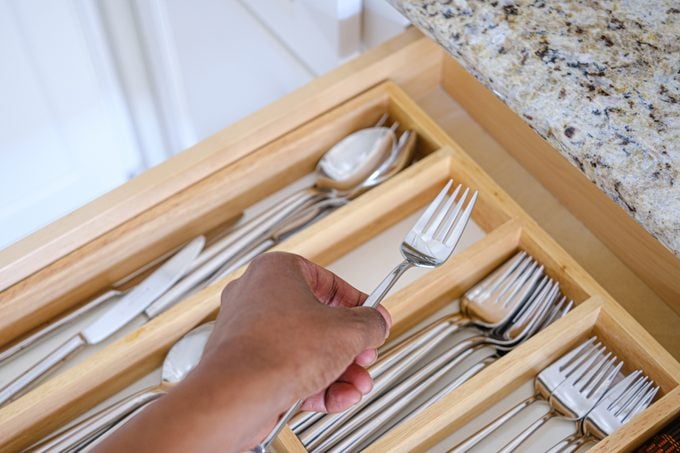 Woman Grabs a Fork From Kitchen Drawer