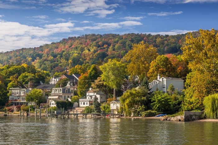 Landscape with Trees in Autumn Colors (Foliage), Hudson River, Waterfront Houses, Pier and Blue Sky, Nyack, Rockland County, Hudson Valley, New York.