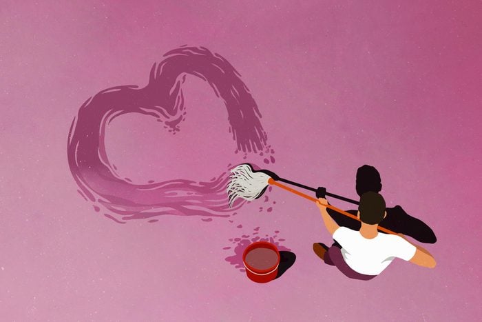 Man drawing heart-shape with mop