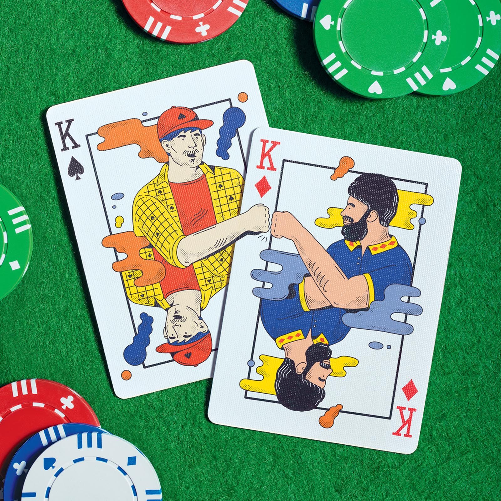 Playing cards with illustrations of two men giving each other a fist bump, with poker chips on a green poker table background