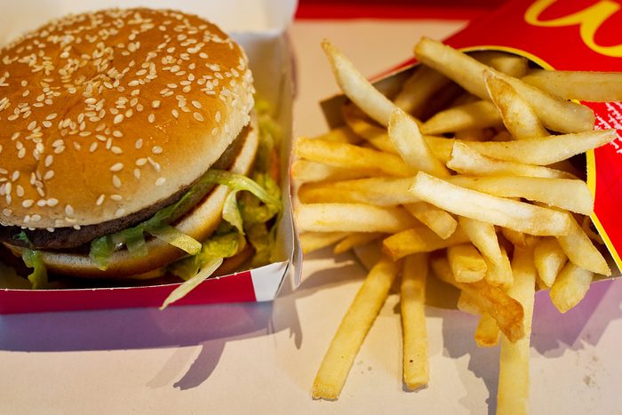 A Large Frency Fry and Big Mac Meal Rest on a Tray in a Mcdonald's fast food chain restaurant