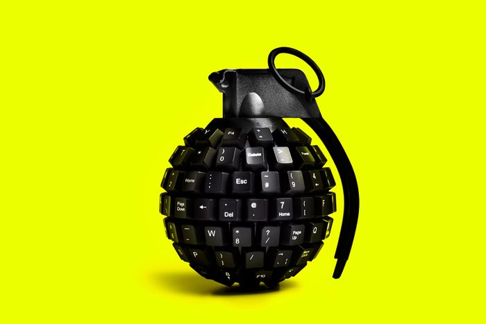 Cyber Attack Grenade Made From Computer Keyboard On Yellow Background