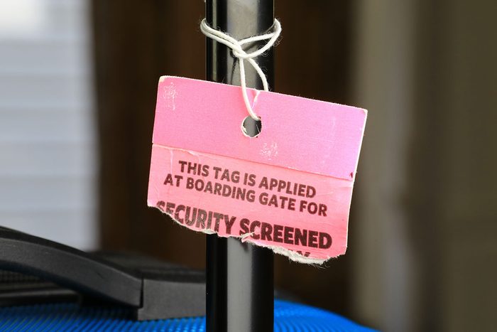 Luggage Tag After Tsa Screening On A Suitcase
