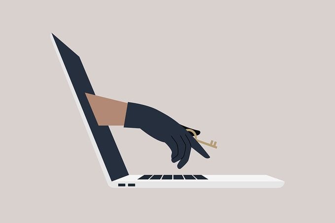 A Hand In A Black Leather Glove Holding An Access key reaches through computer screen to steal personal data concept