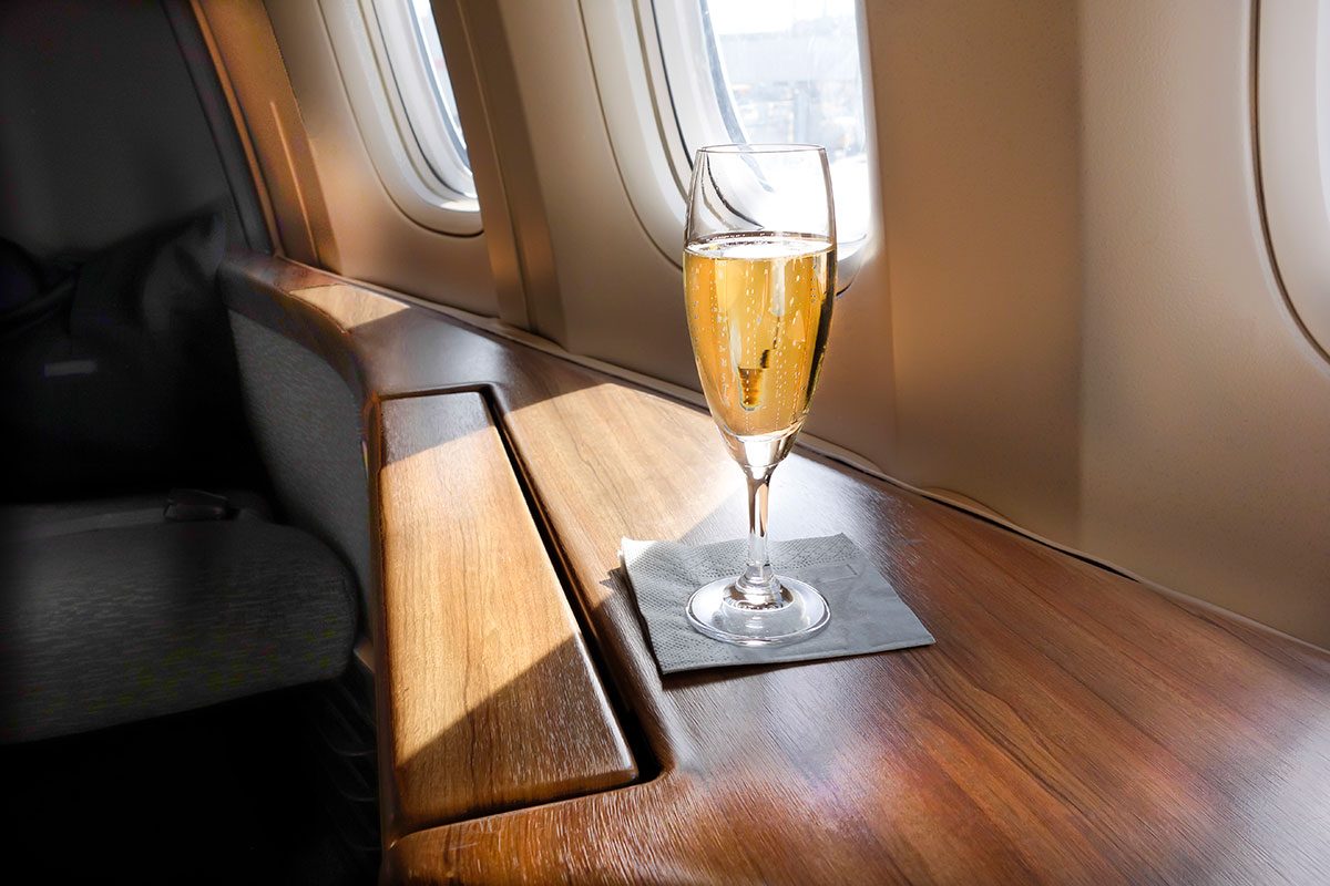 Glass of Welcoming Champagne Awaits a Passenger in First Class on an Airline Flight