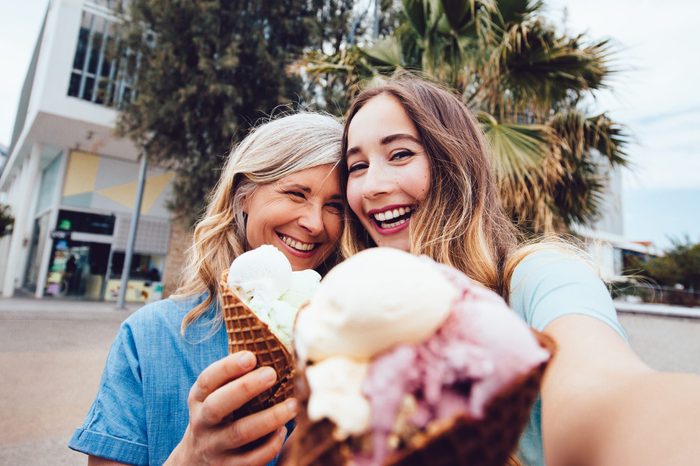Senior mother and daughter taking a selfie while eating ice-cream