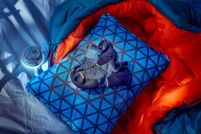 sock on a pillow with a sleeping bag inside a tent