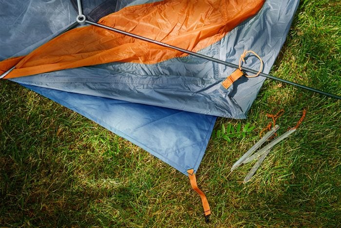 a tent footprint laid down beneath a tent for camping