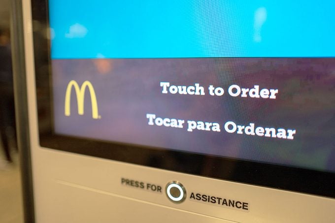 Automated touch screen ordering system at McDonald's fast food restaurant in Santa Nella, California, allowing visitors to place their order and receive their food via a large touch screen interface