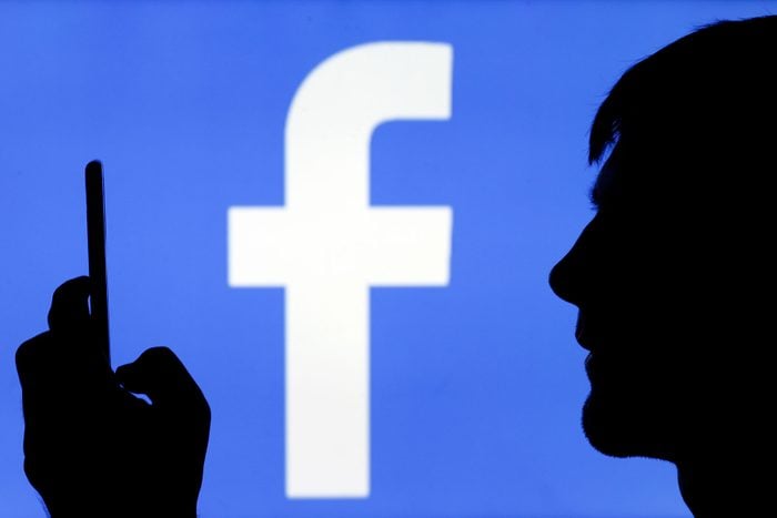 Facebook Logo with the silhouette of an unknown man