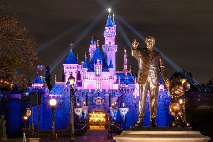 a view of Sleeping Beauty Castle in Disneyland Park illuminated during a special live streamed moment to welcome Cast Members back to the resort on April 26, 2021 at Disneyland Resort in Anaheim, California