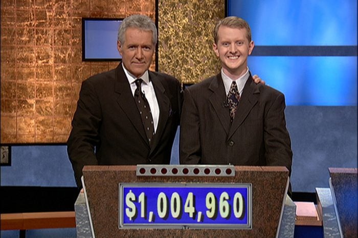 Jeopardy Game Show Host Alex Trebek poses with contestant Ken Jennings With His Earnings from His Record Breaking Streak on the Gameshow