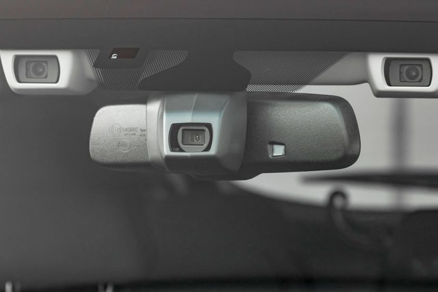 Close up shot of modern car safety system cameras and radars in the rear view mirror area of the vehicle