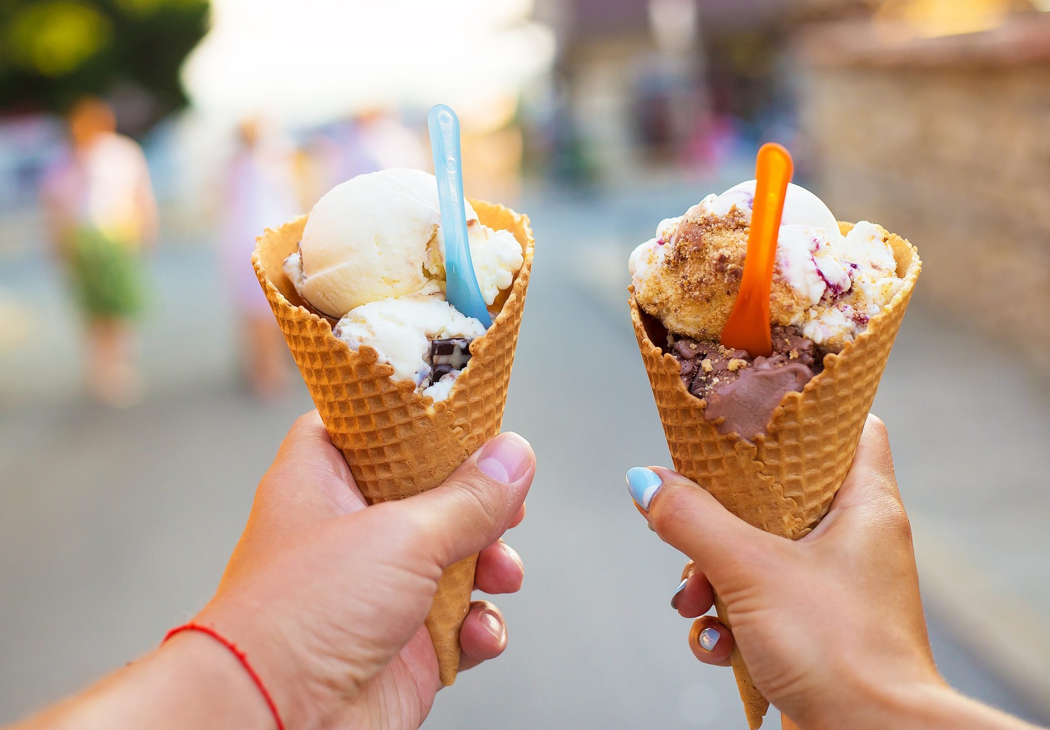 Beautiful bright ice cream with different flavors in the hands of a couple