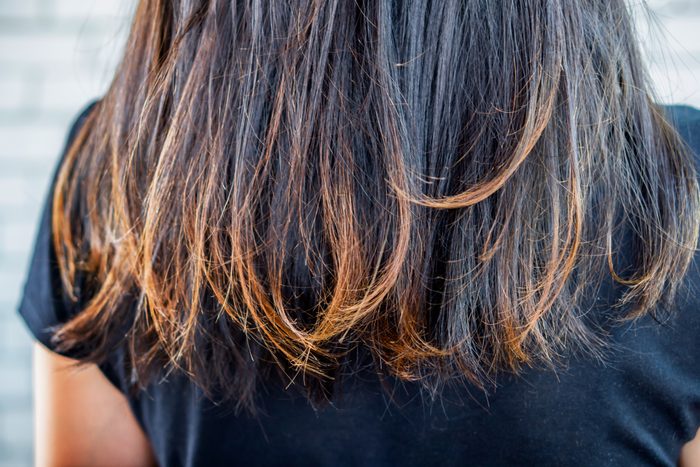 woman damaged hair split ends ,dry and unhealthy hair