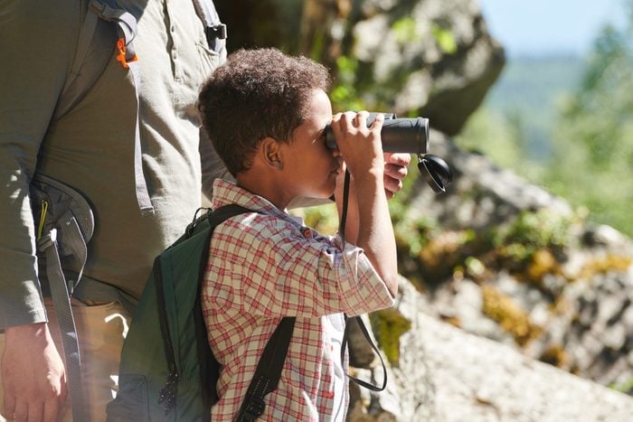 Little boy using binoculars