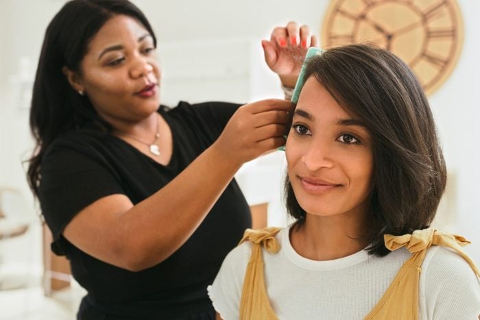 Shot of a young woman getting her hair done at a salon