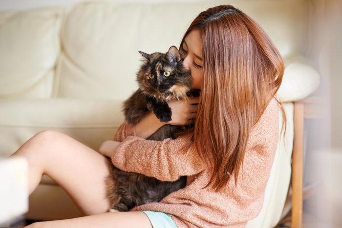 woman cuddling her cat