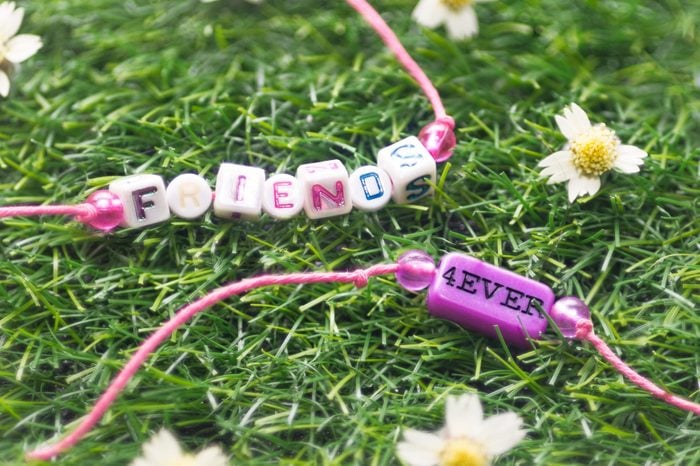 two friendship bracelet on grass
