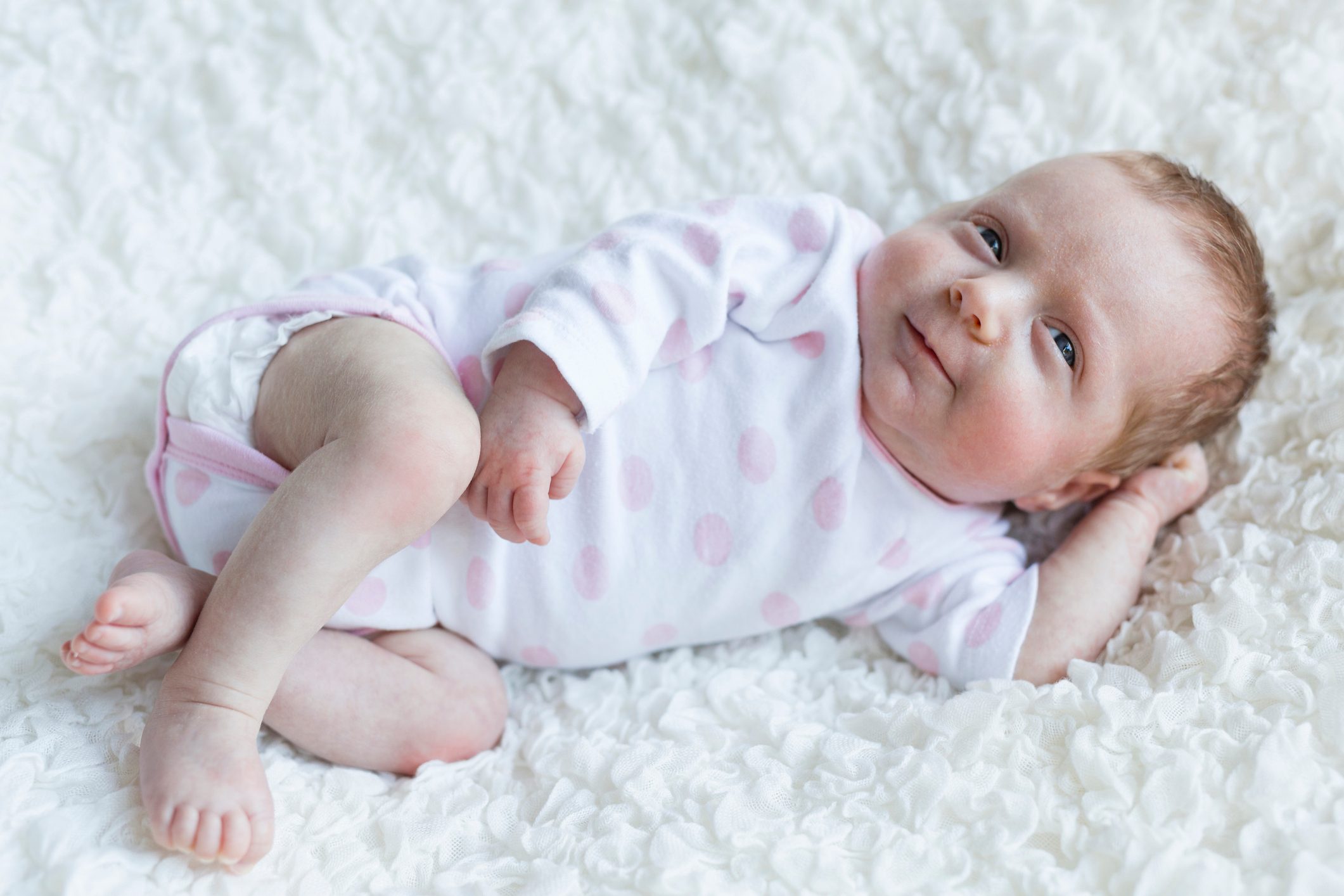 Portrait of smiling newborn baby girl
