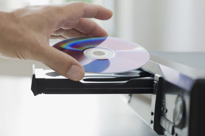 Man inserting dvd