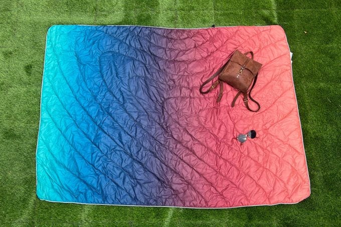 Rumpl Camping Blanket rolled out on the grass