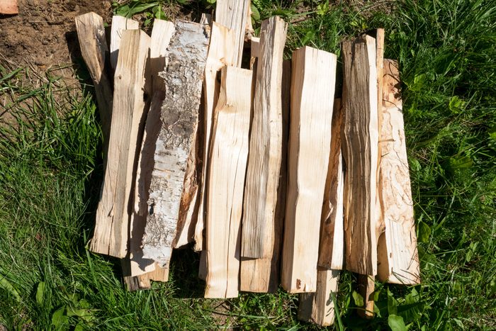 Bundle of wooden firewood slivers on grass top view