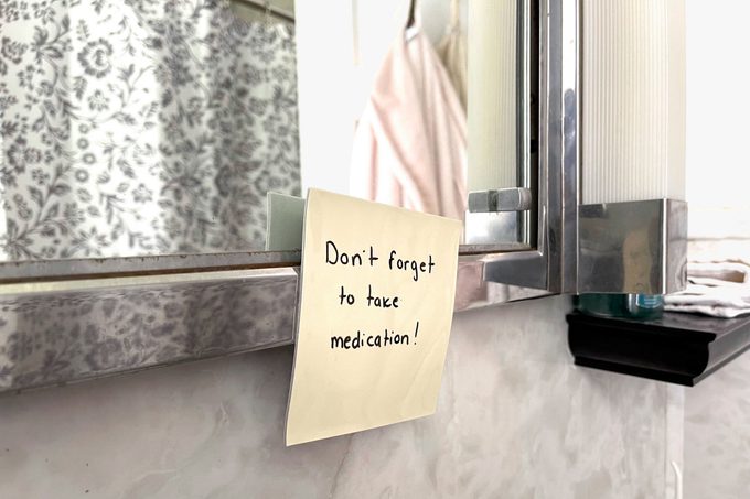 Reusable Sticky Notes on the frame of the bathroom mirror