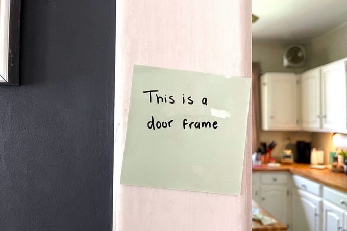 Reusable Sticky Note on a wood door frame